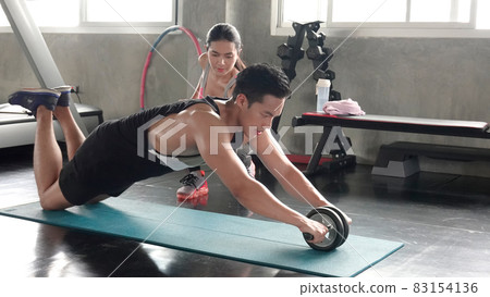 FITNESS AND WORKING OUT concept. Active lifestyle of Young people exercise and workout at fitness gym. FITNESS AND WORKING OUT concept. Active lifestyle of Young people exercise and workout at fitness gym. 83154136