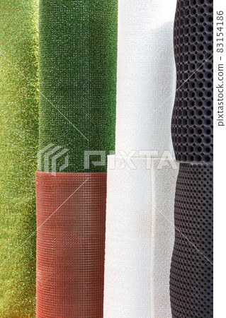 Mats roll plastic artificial synthetic grass green white brown and black rubber honeycomb floor covering. Industrial background 83154186
