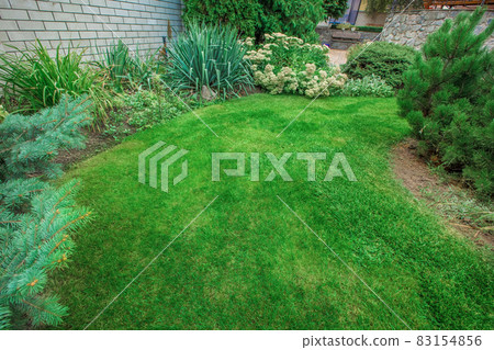 Front Yard Landscaping. A beautifully manicured front yard with a garden full of perennials and annuals. Front Yard Landscaping. A beautifully manicured front yard with a garden full of perennials and annuals. 83154856