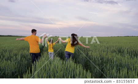 Happy family run through green field with wheat, childhood dream, wheat plantation for production of healthy food bread products, agricultural business, agriculture, mother father and little kid Happy family run through green field with wheat, childhood dream, wheat plantation for production of healthy food bread products, agricultural business, agriculture, mother father and little kid 83155657
