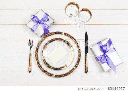 Holiday table setting on wooden table in lilac colors 83156057