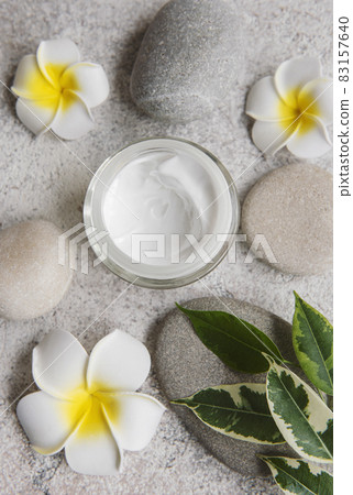 Spa treatment with massage stones and moisturizing cream 83157640