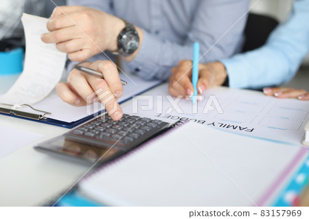 A couple makes a family budget based on bills A couple makes a family budget based on bills 83157969