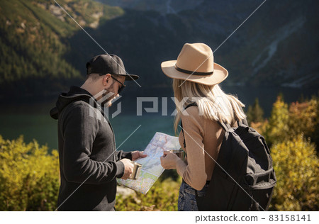 Young tourist couple, man and woman, on hiking path in mountains 83158141