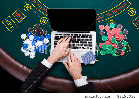 casino, online gambling, technology and people concept - close up of poker player with playing cards casino, online gambling, technology and people concept - close up of poker player with playing cards 83159055