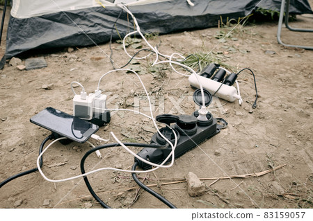 Smartphone and powerbanks charging on the ground Smartphone and powerbanks charging on the ground 83159057