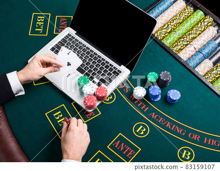 casino, online gambling, technology and people concept - close up of poker player with playing cards casino, online gambling, technology and people concept - close up of poker player with playing cards 83159107