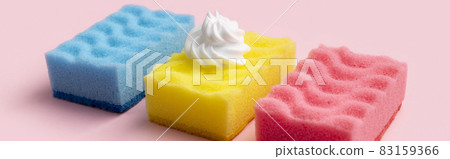 Colorful sponges for dishwashing with foam on pink background 83159366