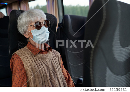 Senior female in casualwear, sunglasses and protective mask 83159381