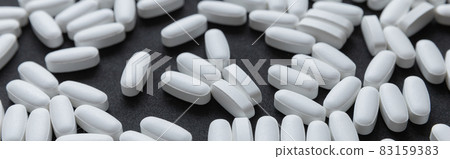 White tablets pills pattern over dark background 83159383