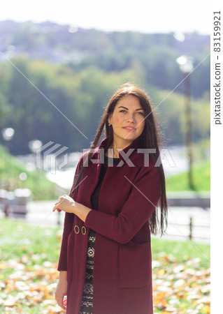 Portrait of a joyful young woman enjoying in the autumn park. Portrait of a joyful young woman enjoying in the autumn park. 83159921