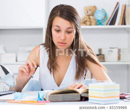 Female schooler is preparing herself for exams Female schooler is preparing herself for exams 83159966