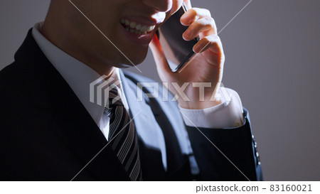 Middle-aged businessman calling on a smartphone (business image) Middle-aged businessman calling on a smartphone (business image) 83160021