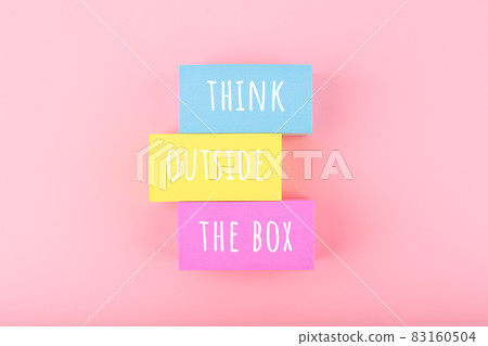 Creativity concept. Think outside the box written on colorful rectangles on bright pink background Creativity concept. Think outside the box written on colorful rectangles on bright pink background 83160504