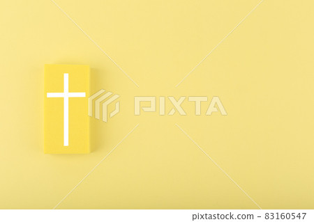 Modern religious minimal concept of hope with christian cross on bright yellow background with copy space 83160547