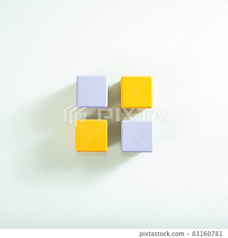 The adove view on four wooden cubes in two trend colors on the light background. 83160781