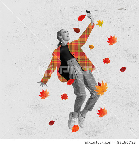 Contemporary art collage of woman in suit with drawn jacket taking selfie under falling autumn leaves isolated over textured gray background 83160782