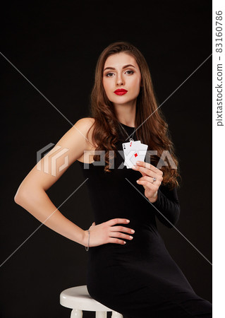 Attractive young woman holding the winning combination of poker cards 83160786