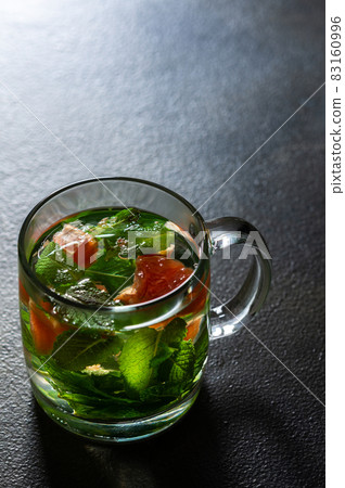A healthy hot drink with mint and grapefruit 83160996