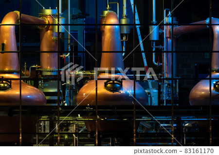 Copper stills for the production of irish Whiskey seen from the public aquare in Ardara, County Donegal - Ireland 83161170