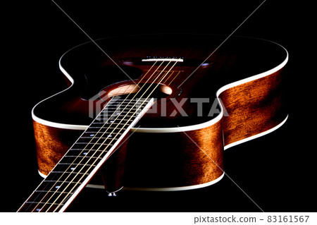Mahogany Acoustic Guitar Oblique View on Black Mahogany Acoustic Guitar Oblique View on Black 83161567