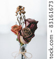 Dried rose flowers in a bay window vase 83161673