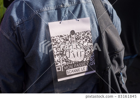 Colmar - France - 9 October 2021 -  people protesting with banner and qr code in french, mon pass scanne le, in english : my pass, scan it Colmar - France - 9 October 2021 -  people protesting with banner and qr code in french, mon pass scanne le, in english : my pass, scan it 83161845