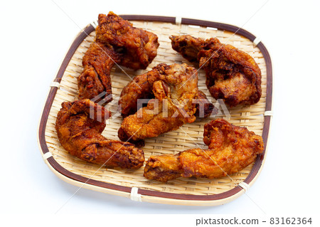 Fried chicken necks in bamboo basket on white background. 83162364