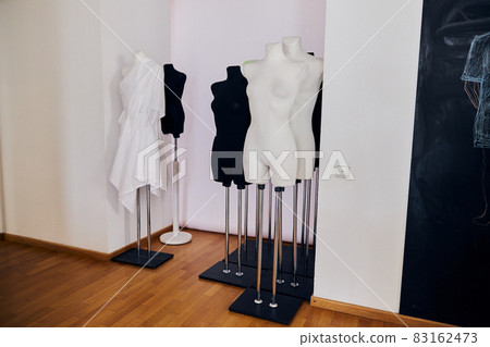Dummies stand in white wall aumbry in light fashion design studio 83162473