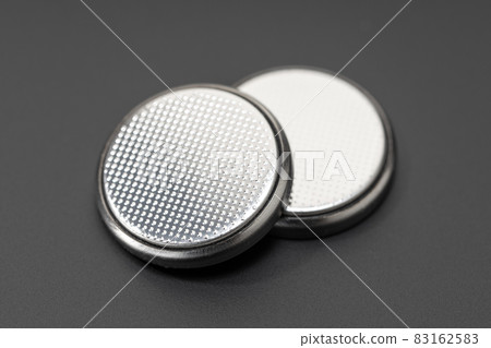 Button cell battery or coin cell isolated on black background 83162583