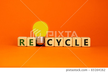 Recycle concept. Wooden cubes with word 'Recycle'. Yellow light bulb. Beautiful orange background. Business and recycle concept. Copy space. Recycle concept. Wooden cubes with word 'Recycle'. Yellow light bulb. Beautiful orange background. Business and recycle concept. Copy space. 83164162