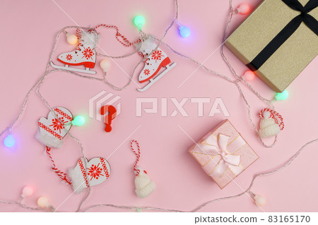 Question mark. Choosing a gift for New Year or Christmas. Top view, pink background. Copy space Question mark. Choosing a gift for New Year or Christmas. Top view, pink background. Copy space 83165170