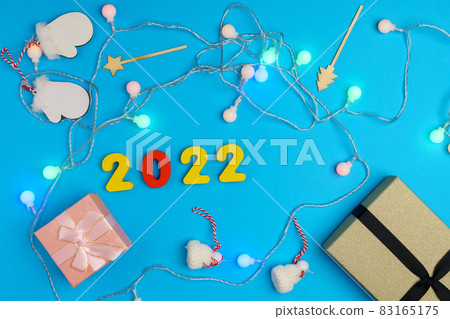 Christmas gift box for the New Year 2022 Christmas holiday on a blue background. Christmas gift box for the New Year 2022 Christmas holiday on a blue background. 83165175