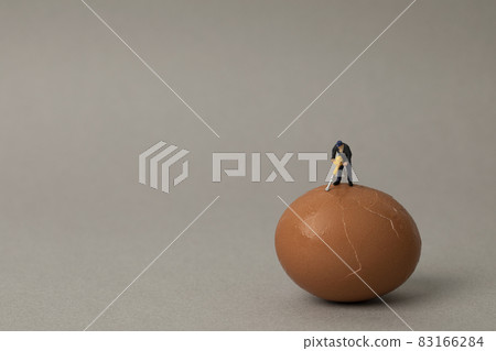 miniature man breaking eggs miniature man breaking eggs 83166284