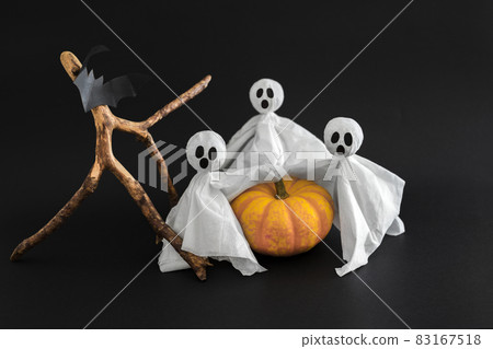 Three ghosts, bat and pumpkin on black background. Symbols of Halloween . Three ghosts, bat and pumpkin on black background. Symbols of Halloween . 83167518