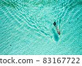 Top down view of a girl swimming in a lagoon 83167722