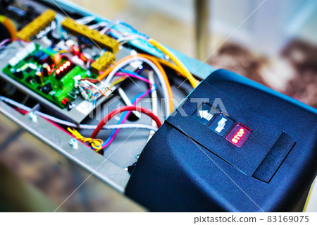 Setting up the turnstile for passing at the entrance. Device with wires and chips.background 83169075