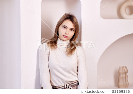 Portrait of slim white woman at home. 83169356