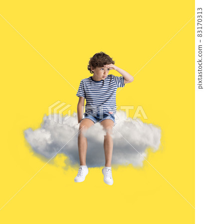 Creative collage with little preschool boy sitting on white cloud and flying at sky. Concept of childhood, dreams, fantasy Creative collage with little preschool boy sitting on white cloud and flying at sky. Concept of childhood, dreams, fantasy 83170313