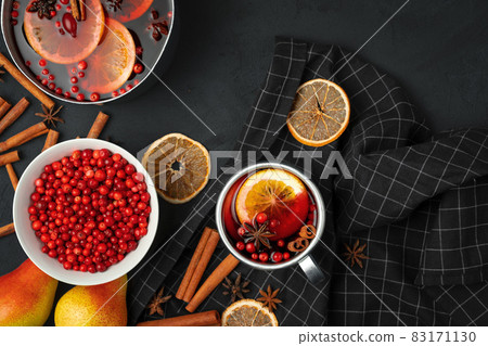 Top view of hot mulled wine and spices on black background Top view of hot mulled wine and spices on black background 83171130