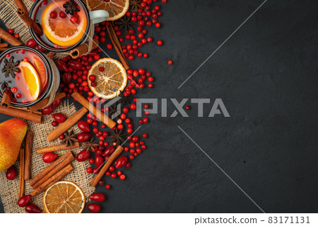 Top view of hot mulled wine and spices on black background 83171131