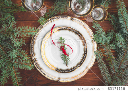 Christmas table setting with pine tree branches and decorations top view Christmas table setting with pine tree branches and decorations top view 83171136