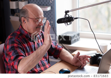 Smiling old elder grandfather talking to webcam on video chat sit at home 83171683