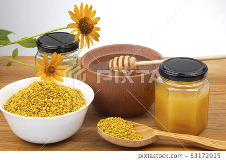 Fresh flower honey in a wooden bowl, spoon, pollen. vitamin food for health and life 83172015