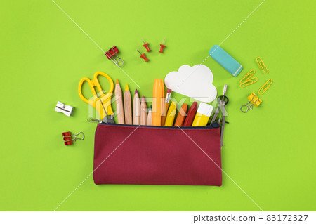 Back to school concept. Pencil case on green background Back to school concept. Pencil case on green background 83172327