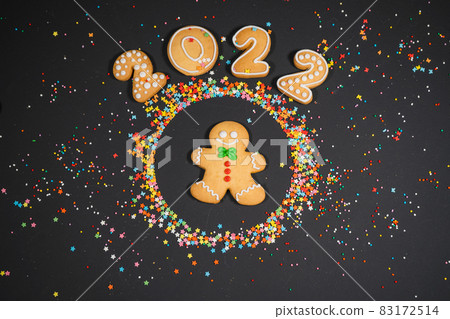 Christmas background with gingerbread on dark surface. Holiday mood card. Top view, copy space. Family traditions, DIY, celebration concept. Festive background with homemade gingerbread cookies. Christmas background with gingerbread on dark surface. Holiday mood card. Top view, copy space. Family traditions, DIY, celebration concept. Festive background with homemade gingerbread cookies. 83172514