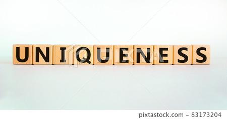 Inclusiveness and uniqueness symbol. Wooden cubes with the word 'uniqueness'. Beautiful white background. Business, inclusiveness and uniqueness concept. Copy space. Inclusiveness and uniqueness symbol. Wooden cubes with the word 'uniqueness'. Beautiful white background. Business, inclusiveness and uniqueness concept. Copy space. 83173204
