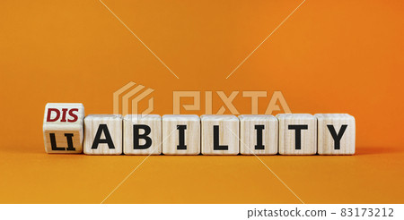 Liability or disability symbol. Turned cubes and changed the word 'liability' to 'disability'. Beautiful orange background. Business, liability or disability concept. Copy space. 83173212