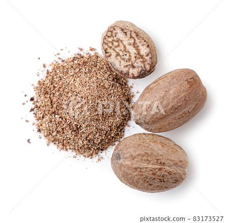 Whole and crushed nutmeg on a white background, isolated. Top view Whole and crushed nutmeg on a white background, isolated. Top view 83173527