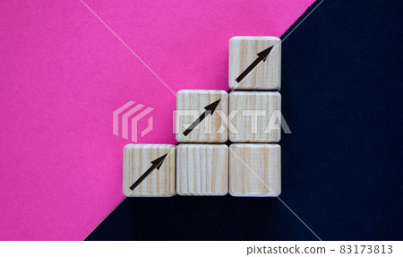 Business concept growth success process. Wood block stacking as step stair on paper purple and black background, copy space. Business concept growth success process. Wood block stacking as step stair on paper purple and black background, copy space. 83173813